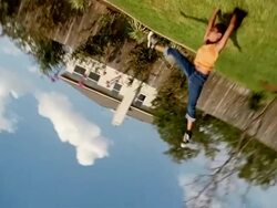 Slow motion medium shot girl doing cartwheels in backyard Stock Footage
