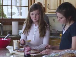 MS TU TD Kids making sandwich while dad takes it with mother in background / Rutland,Vermont, USA Stock Footage