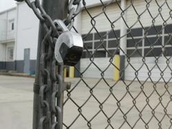 Locked Gate in front of Closed Factory Stock Footage