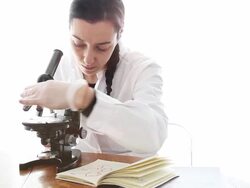 Biologist analyzing using microscope Stock Footage