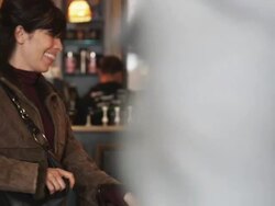 woman choosing and buying a baked good at a bakery Stock Footage
