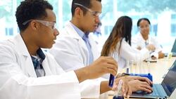 Diverse male scientists work on research project in lab Stock Footage