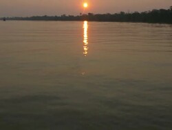 Sunset revealing from amazon river - Tilt view Stock Footage