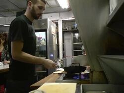 MS Cook cutting sandwich and putting on counter for waitress at classic American diner / Ann Arbor, Michigan, United States Stock Footage