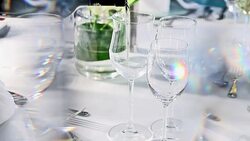 pouring white wine at fine dining table set up behind crystal curtain Stock Footage