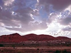 Clouds over Red Cliffs at sunset time lapse Stock Footage