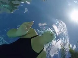 MS SLO MO Woman swimming breast stroke in pool, underwater shot taken from below looking up. Stock Footage
