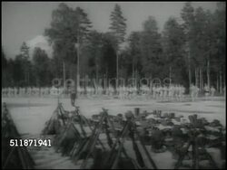 1937: REPUBLIC OF FINLAND: CONSCRIPTION: WS Finnish soldiers exercising in open field at woods edge, arms & uniforms FG, CU Officer, soldiers in uniforms w/ rifles shouldered marching in formation past building.  Mandatory Military Service. Instructional Video
