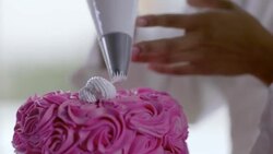 Pastry chef decorates gourmet cake with icing Stock Footage
