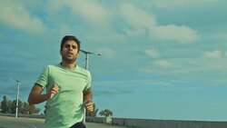 Man running along the waterfront Stock Footage