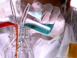 Scientist mixing and pouring liquids Stock Footage