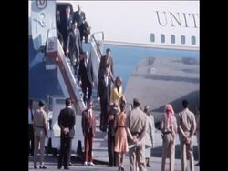 SYND 6-5-74 KISSINGER AND WIFE ARRIVE News Clip