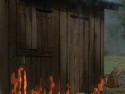 MS Shot of burning shabby wood shack / Unspecified Stock Footage
