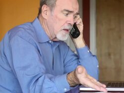 Senior Man Discusses Bills and Documents over Phone Stock Footage