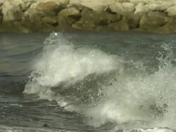 SLO MO wave crashes into seaweed covered rock, Spain Stock Footage