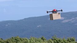 SLO MO TS Drone transporting package above the hilltops Stock Footage