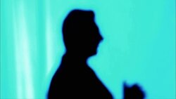 A man in silhouette gestures with his hands as he speaks. Stock Footage