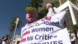 CLEAN : Wall of taco trucks surrounds Trump hotel in debate protest News Clip