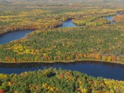 WS ARIEAL View of Meandering Penobscot river with wooded area and autumn color / Maine, United States Stock Footage