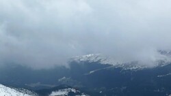 Clouds quickly drift above snowy mountains. Stock Footage