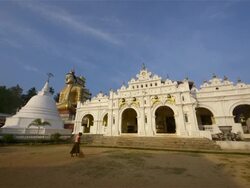 WOMAN SWEEPING AT BUDDHIST TEMPLE Stock Footage