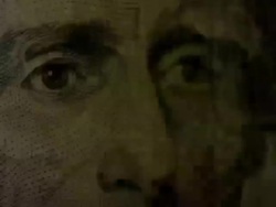 Bright light shines onto and off of Andrew Jackson's face on the US $20 note Stock Footage
