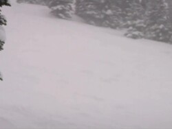 PAN across ski hill with snow falling hard in slow motion / Jasper, Alberta, Canada Stock Footage