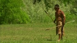 Young Native American Indian boy throwing spear Stock Footage