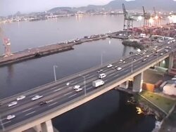 LOW AERIAL, Brazil, Rio de Janeiro along Rio-Niteroi Bridge at dusk Stock Footage
