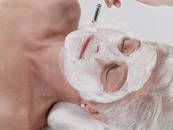 HD: Beautician Applying Facial Mask To Woman's Face Stock Footage