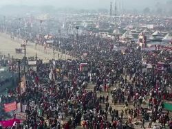 Clothes and saris are dried in the sun on the edge of a vast slowly moving crowd among the tents at the Kumbh Mela, India Stock Footage