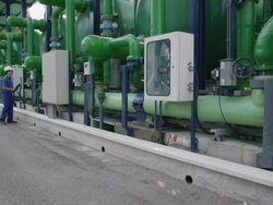 WS Water treatment plant pipework; worker going from control unit to control unit taking notes on clipboard, RED R3D 4K Stock Footage