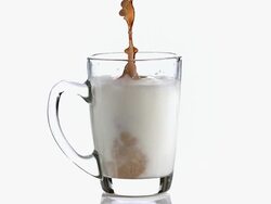 MS SLO MO Coffee being poured in cup of Milk / Vieux Pont, Normandy, France Stock Footage
