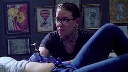 Tattoo artist giving woman stomach tattoo Stock Footage