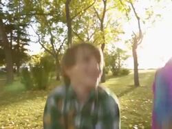 Children playing with autumn leaves in park Stock Footage