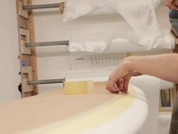 CU Glasser masking surfboard ready for resin / Wadebridge, Cornwall, United Kingdom Stock Footage