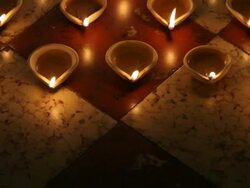 MS POV  Burning clay oil lamps on  floor / Singapore Stock Footage
