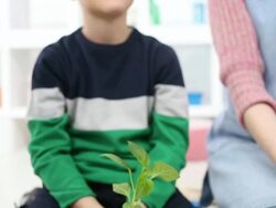 HD: Cute Little Boy Holding Small Plant. Stock Footage