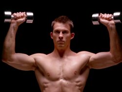 Medium shot muscular man doing chest presses with dumbbells / London Stock Footage
