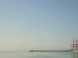 Old bark at the port and lighthouse Stock Footage
