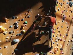 woman climbing on an indoor climbing wall  Stock Footage