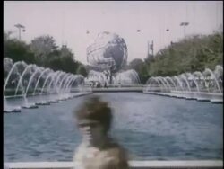 1964 side point of view past fountains in pond with Unisphere in background at NY World's Fair Stock Footage