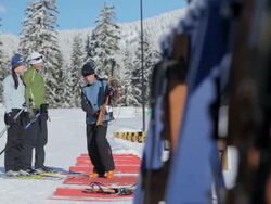 MS PAN One instructor talking with couple in sunny winter day / Whistler ,BC ,Canada Stock Footage