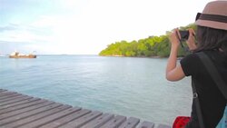 HD Dolly:Woman sitting on wooden bridge and take photo. Stock Footage