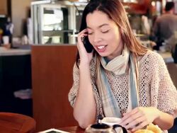 MS Woman using her tablet and talking on her phone in cafe / Santa Fe, New Mexico, United States Stock Footage