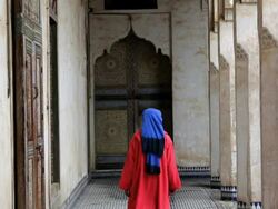 Male in traditional clothing walking in a beautiful ornate old Palace Fez, Morocco, Africa Stock Footage