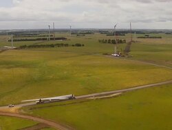 WS AERIAL ZI ZO TS DS View of trailer moving windmill blade / Macarthur, Victoria, Australia Stock Footage