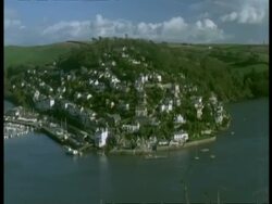 T/L WA high angle view of River Dart leading out to sea, Pan left to Kingsbridge Town, Dartmouth, boats and ferries on river and in harbour Stock Footage