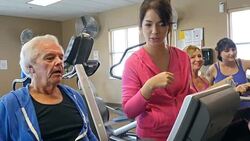 Mixed race physical therapist works with senior male client Stock Footage