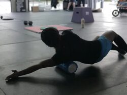 Rear full frame view. Jonice rolls her right oblique muscle. Stock Footage